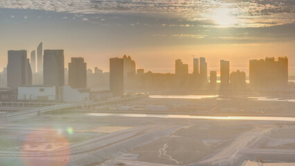 Wall Mural - Buildings on Al Reem island in Abu Dhabi at sunset timelapse from above.