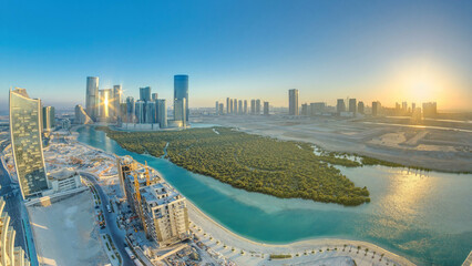 Wall Mural - Buildings on Al Reem island in Abu Dhabi at sunset timelapse from above.