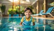 © Micaela - Smiling little boy playing at an indoor swimming pool