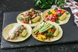 Fototapeta Kuchnia - set of delicious fresh colorful tacos on a dark background