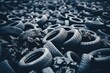 A collection of worn-out tires scattered on the ground in a haphazard manner, creating a messy scene of rubber products.