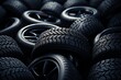 A pile of new tires scattered on the ground in a haphazard mannerd, creating a messy scene of rubber products.