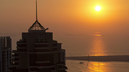 Wall Mural - Dubai marina sunset at the sea from top aerial timelapse