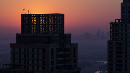 Wall Mural - Sunrise in Dubai Marina with towers from skyscrapers rooftop, Dubai, UAE timelapse