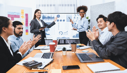 Wall Mural - Business people celebrate after successful presentation or meeting on data analysis display on TV screen. Happy team gathers in office room, cheer to collaboration with celebratory gesture. Concord