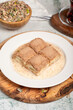 © enezselvi - Cold baklava with pistachios on a wooden background. Turkish cuisine delicacies. Ramadan Dessert. local name soğuk baklava