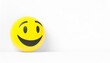 Classic yellow smiley face with a broad smile, placed on a white background, creating a minimalist happy concept.