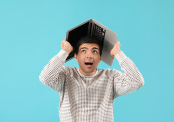 Poster - Male programmer with laptop on blue background