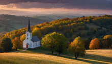 A White Church With A Tall Spire Amidst Autumn-colored Trees On A Hill With A Dramatic Sunset In The Background