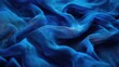 Close up shot of a vibrant blue fabric texture. Perfect for backgrounds or design projects