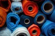 A pile of different colored rolls of fabric, perfect for textile design projects