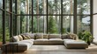 Beige corner sofa against of big windows. Minimalist interior design of modern living room in country house in forest. 