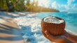 Tropical beach with hands holding a coconut filled with hydrating coconut water
