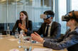 © ChaoticMind - Business people using VR headsets during a collaborative meeting in a modern office space
