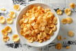 Top view of cornflakes in a white bowl on the table
