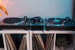 A DJ's turntable setup with headphones and vinyl collection, ready to mix music.