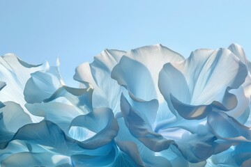 Aufkleber - An artistic composition of light and shadow playing across the soft, undulating petals of flowers in shades of blue, suggesting movement and lightness