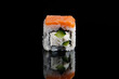 Philadelphia sushi roll on black background with reflection. Uramaki rolls.