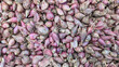 A vast collection of shallots with papery pink skins, essential for culinary flavoring.