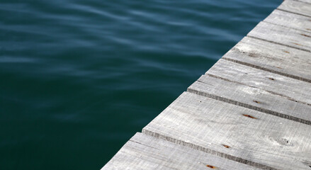 Wall Mural - Wooden boardwalk with blue sea