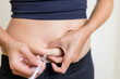 IVF and infertility treatment concept, woman have injection on her belly