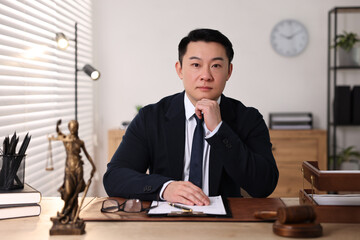 Notary working at wooden table in office