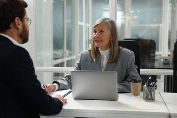 Poster - Lawyer working with client at table in office