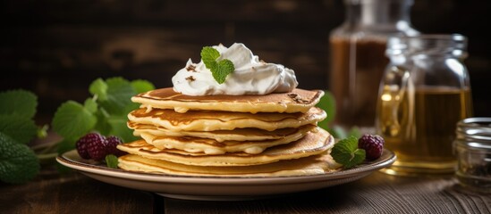 Wall Mural - A dish of baked goods made from staple food ingredients, pancakes topped with whipped cream, served on a plate