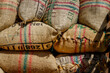 Burlap bags with Colombian coffee beans stacked in a truck