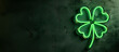 four leaf clover neon sign on a dark plaster wall. With area for text or image on left side. st patricks day card. 