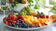A platter of colorful fruit including juicy strawberries plump blueberries and sliced peaches perfect for enjoying with a glass of crisp chilled white wine.