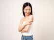 © Chanakon - Vaccination. Young beautiful asian woman getting a vaccine protection the coronavirus. Smiling happy female showing arm with bandage after receiving vaccination. On isolated white background.