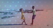 African American couple holding hands on a beach
