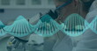 Image of rotating DNA strand over scientist wearing lab coat working in a lab