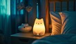 © LimeSky - Cute cat shaped bedside lamp on a night table next to a bed in a dark bedroom