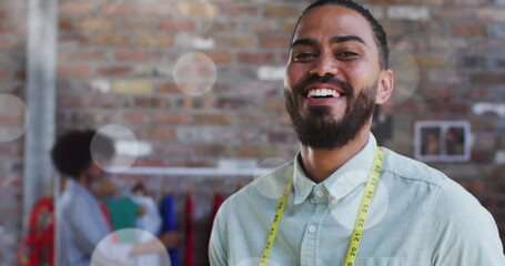 Poster - Image of spots of lights over biracial male tailor