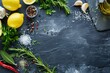 Food background with herbs spices olive oil salt lemons and vegetables on slate and wood
