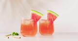 Fototapeta Sport - Two glasses of watermelon juice are on display, with copy space