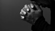 © herlanzer - black man praying to god with hands together Caribbean man praying on black background with people stock photos stock photo