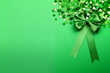 green bow-tie, shamrocks confetti straws isolated on bright green background, space for text on right