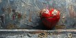 A red stone heart in a cracked ground as a symbol for a broken heart and lovesickness,