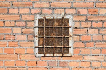 Sticker - Abandoned warehouse window. Rusty grate window. Safety security protection. Red brick wall with metal grate window cover. Basement background.