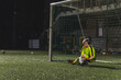 © PoppyPix - girl goalkeeper with a ball during a match in the late evening, girls playing soccer. High quality photo