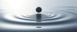 As a droplet gently breaks the surface tension of the water, it sets off a chain reaction of graceful ripples that spread across the undisturbed surface, forming intricate patterns