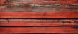 A detailed view of a rectangular patterned red hardwood plank wall with brickwork, showcasing various tints and shades of wood stain
