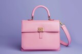 Fototapeta Kuchnia - Beautiful trendy smooth women's handbag briefcase in pink color on a violet studio background.
