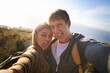 Funny, face and hiking couple with selfie in nature for bonding, fun or goofy memory at sunset. Happy, love and people embrace for silly profile picture, photography or social media travel blog photo