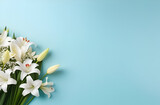 Fototapeta Tulipany - Beautiful white lilies on the pastel blue background. Horizontal background for banner, greeting card, invitation. Women's Day, Valentine's Day, wedding.