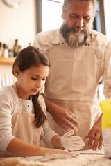 Sticker - Girl, child and grandpa with dough in kitchen for cooking, baking and teaching with support and helping. Family, senior man and grandchild with flour for preparation in home with bonding and learning