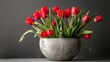A vase overflowing with vibrant red flowers rests gracefully atop a table